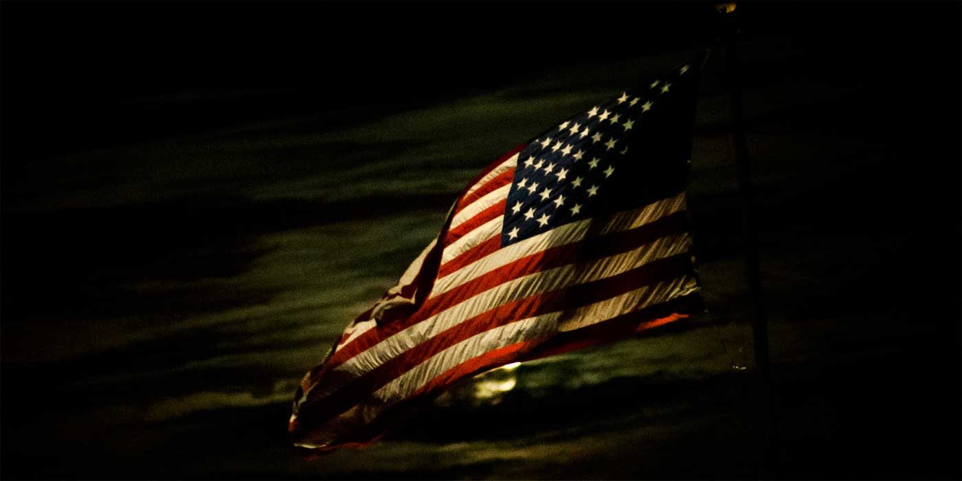 Photo of an American flag in the dark