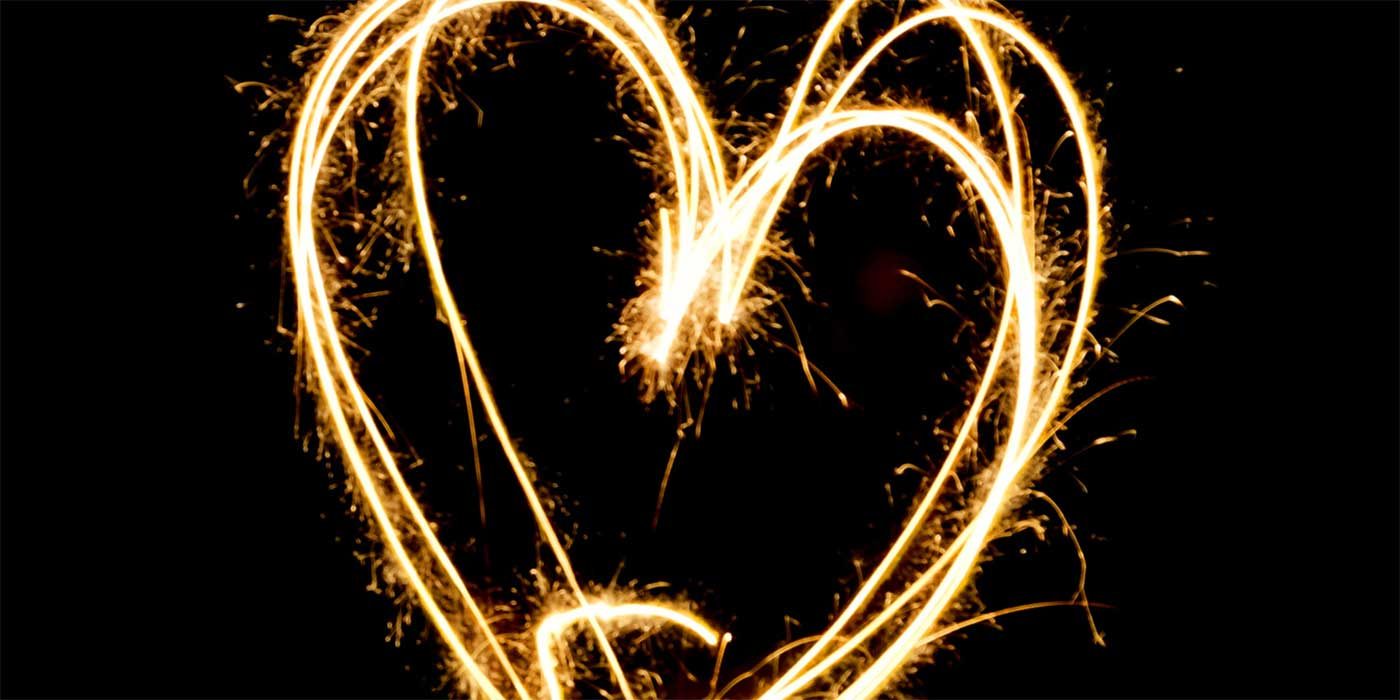 Photo of a sparkler drawing a heart in the air