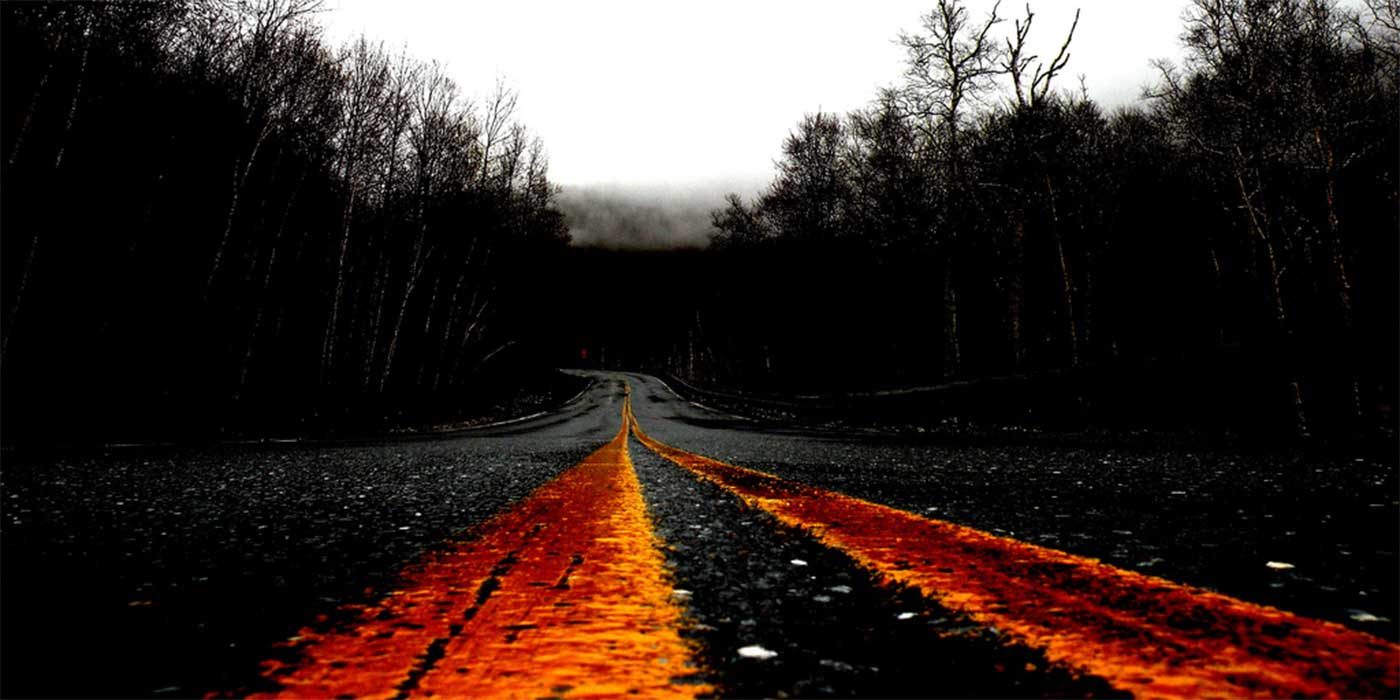 Photo of a spooky road at night