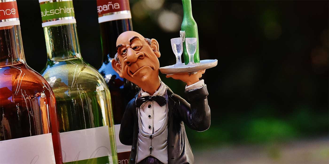 Photo of a toy waiter with wine bottles