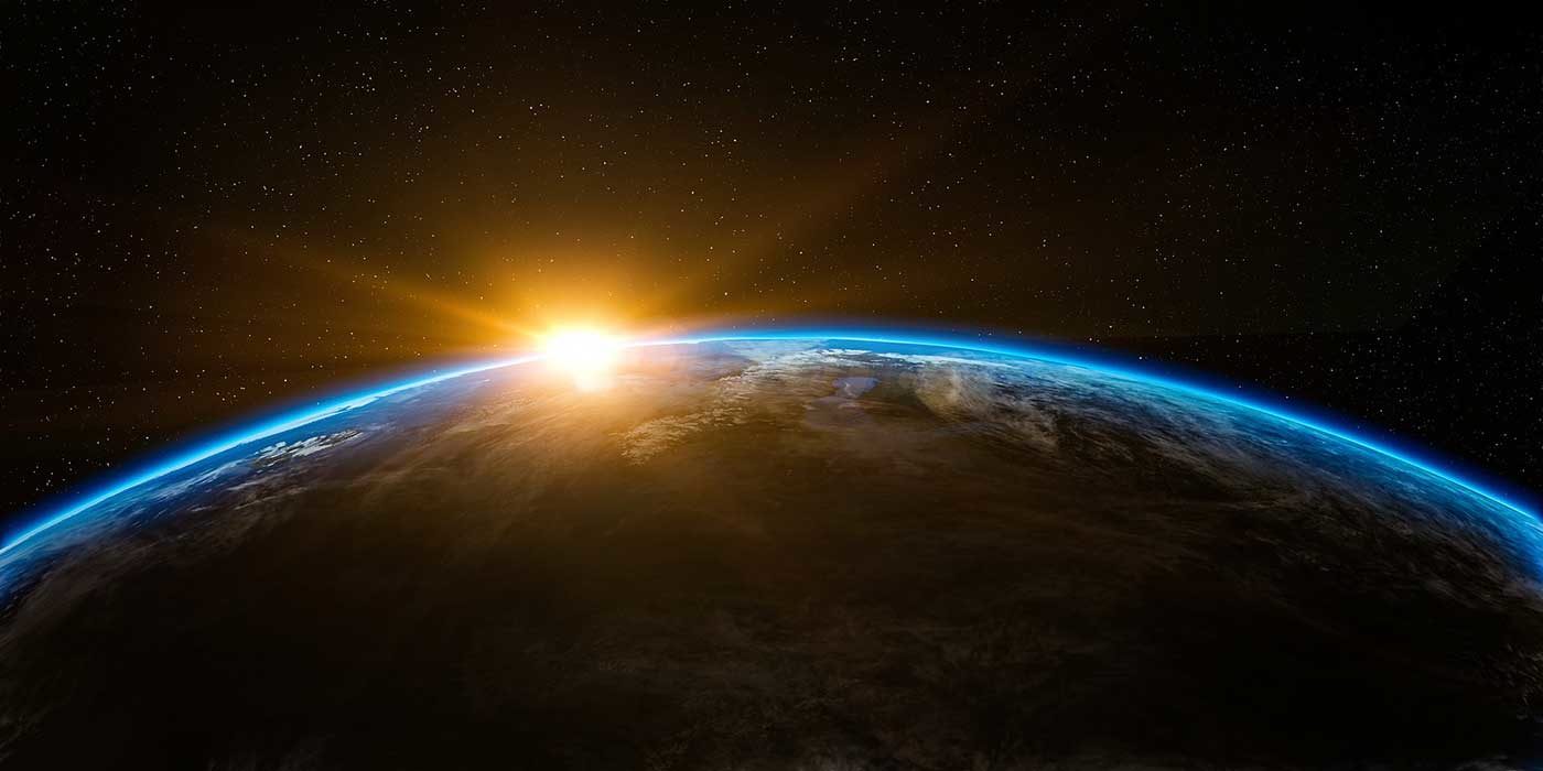 Photo the world from space with the sun rising above it