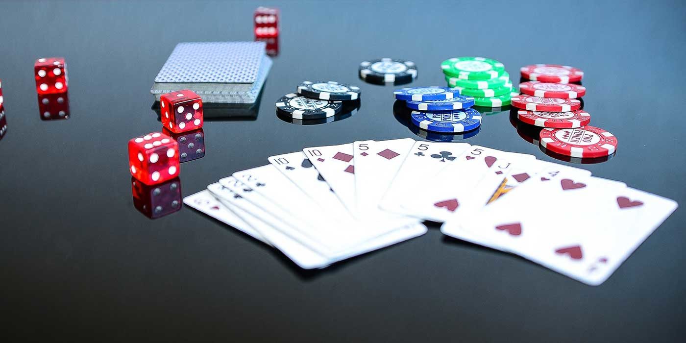 Photo of cards, poker chips and dice