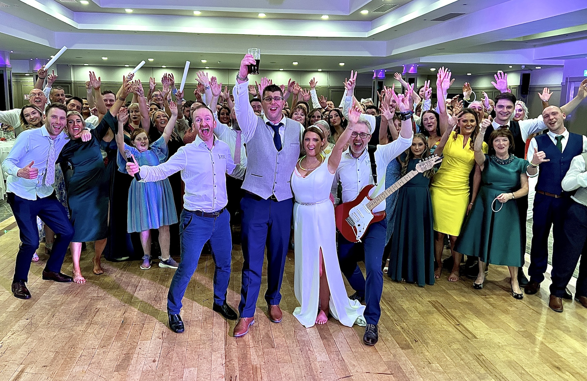 Photo of Ciara and Marty with Rod and Neil from Juice Wedding Band Northern Ireland NI, along with their wedding guests in the Hillgrove Hotel Monaghan